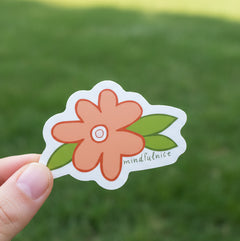 Mindfulnice Daisy peach colored Flower Vinyl Sticker Decal shown in front of a green lawn