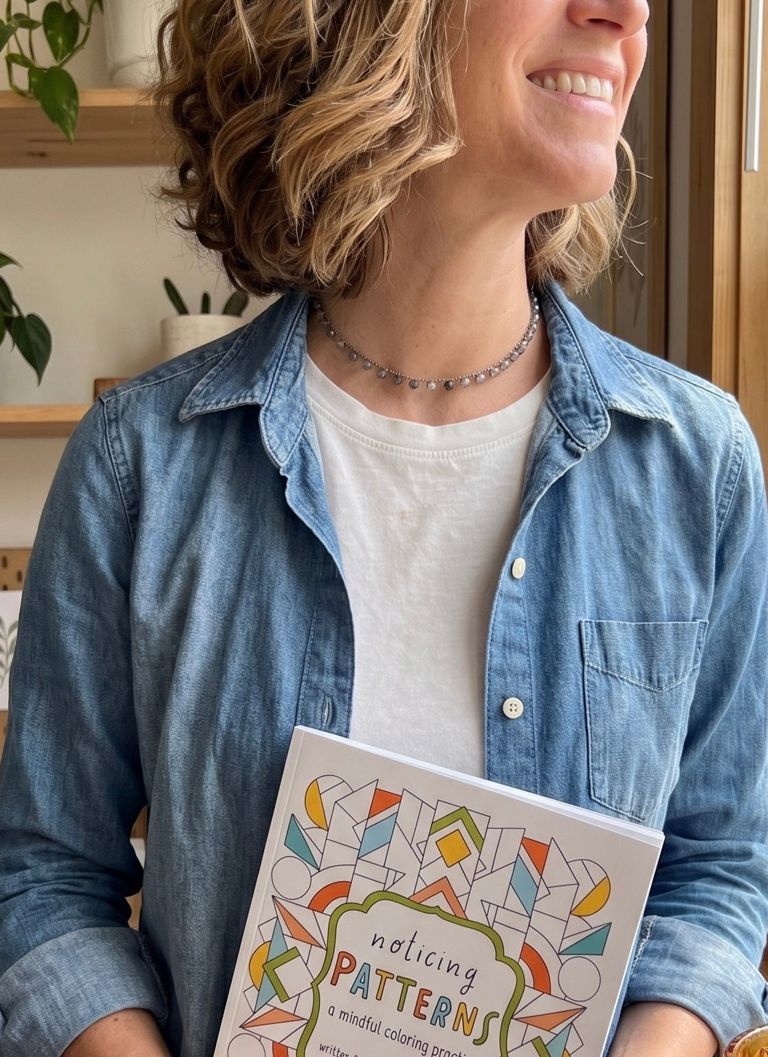 the artist holding the mindful coloring book